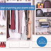 A white shelving unit displaying various clothing items and leather accessories, including hangers and bags.
