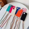 A collection of colorful smartphones with metal shoulder straps laid out on a white surface.
