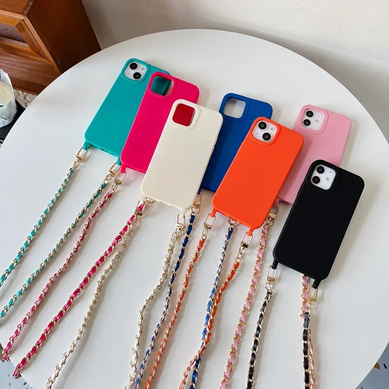 A collection of colorful smartphones with metal shoulder straps laid out on a white surface.
