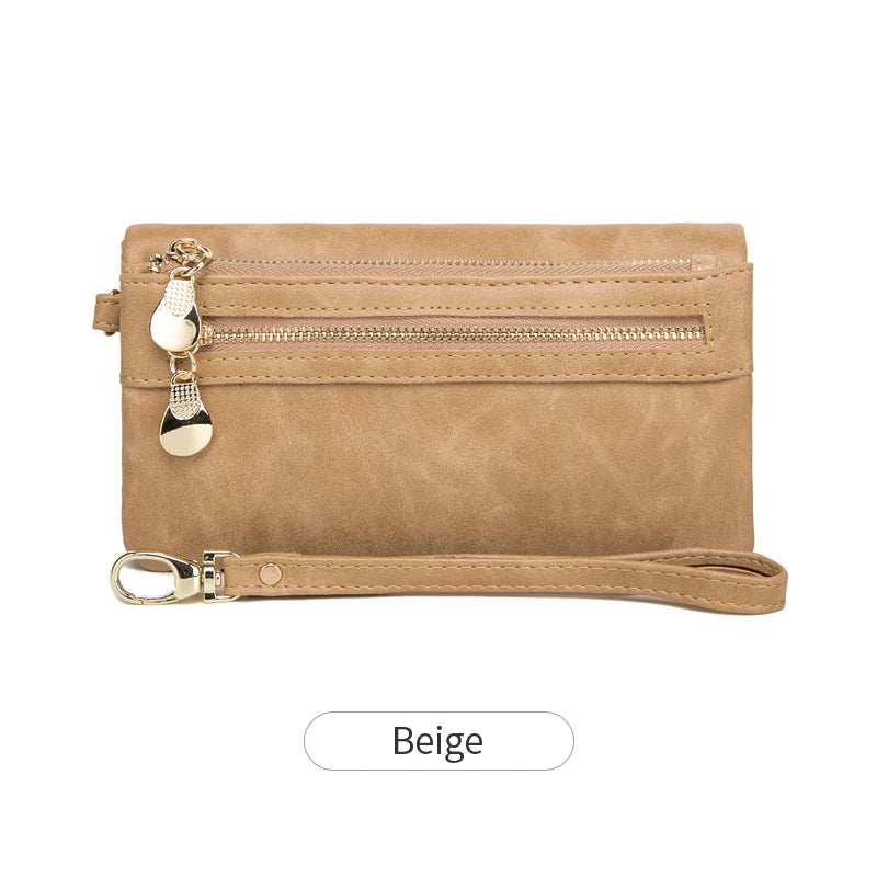 A tan leather wallet with a double zipper closure and a gold-toned charm.