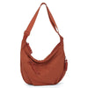A brown soft nylon crossbody shoulder bag with an adjustable strap.