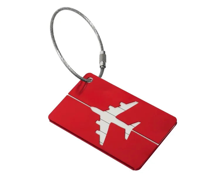 A red luggage tag with a white airplane silhouette attached to a silver cord.