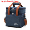 A dark blue insulated double-layer lunch bag with brown straps and zippered compartments.