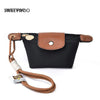 A black compact coin purse with a faux leather flap and a brown leather strap and keychain.