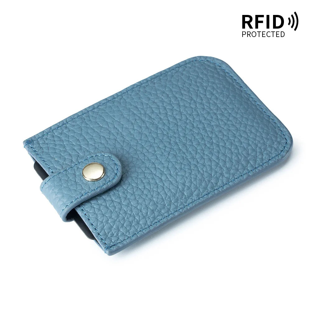 A teal genuine leather slim card holder with a stitched texture and a leather flap.