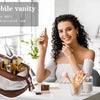 A woman holds an elegant PU leather travel cosmetic organizer bag filled with makeup brushes and products.