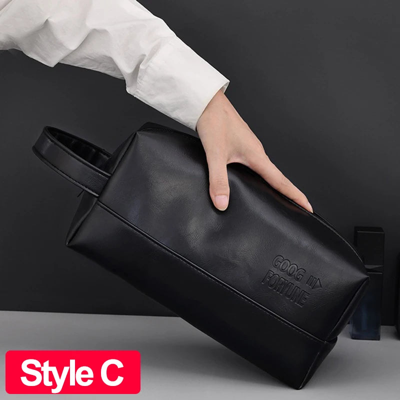 A hand is holding a black waterproof PU leather toiletry bag with the GOOG III FORUM logo on it.