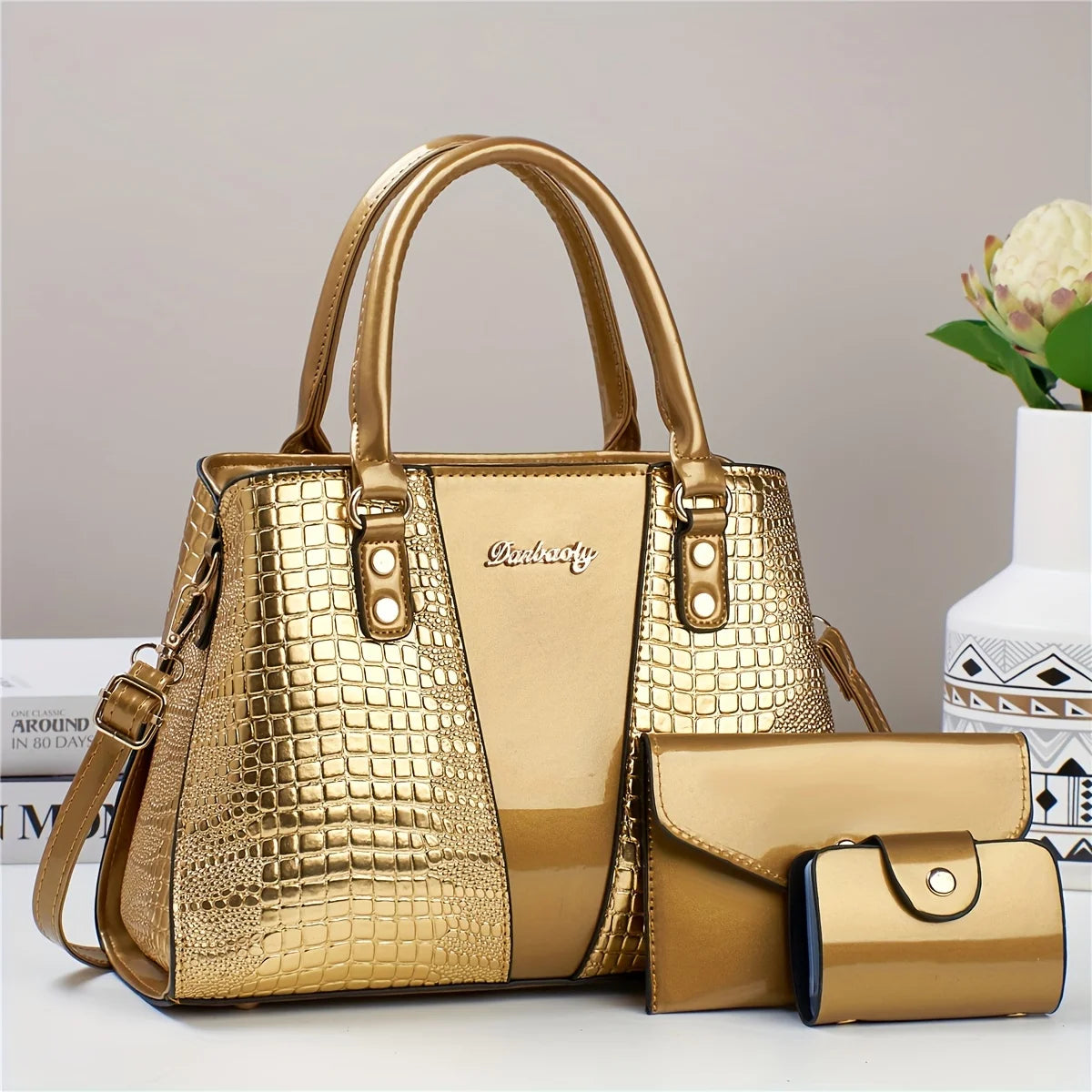 Set de bolso de cuero trenzado de cocodrilo dorado, con una bolsa grande y un clutch pequeño.