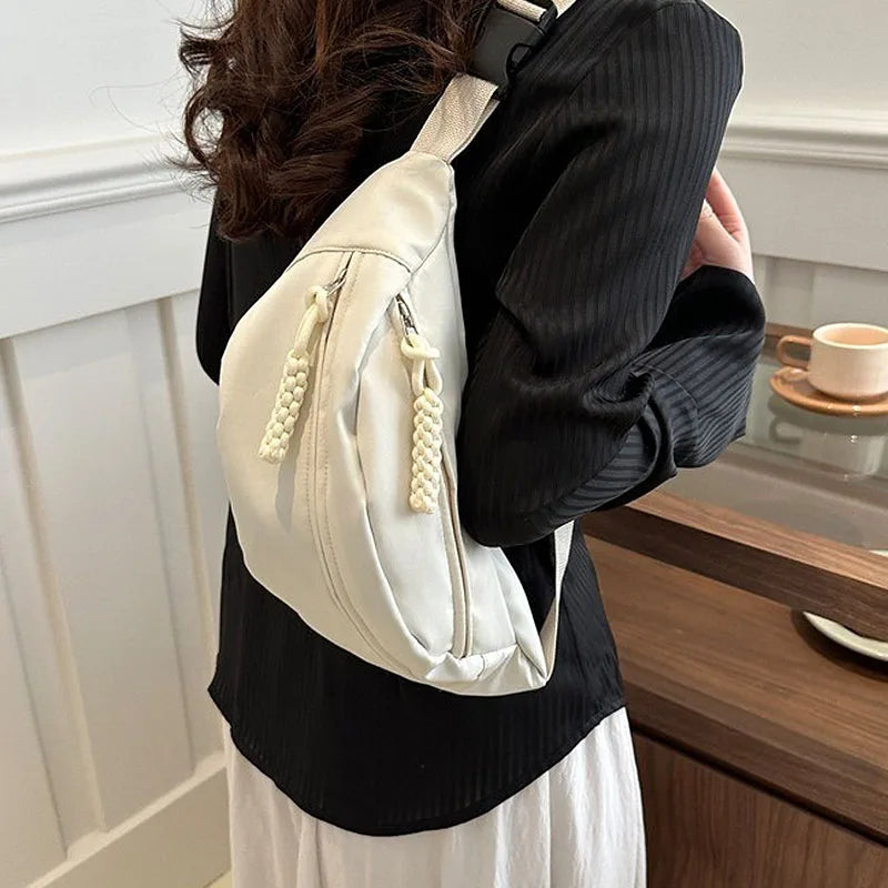 A person is holding a beige anti-theft waist pack for travel or running.