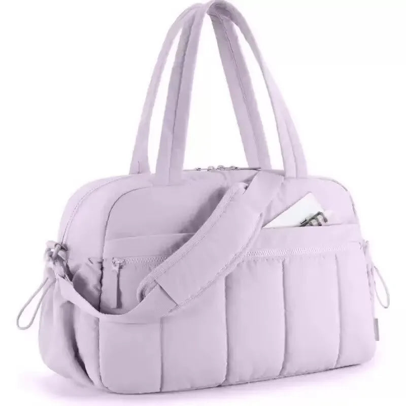 A light purple versatile large capacity travel and fitness bag with padded compartments.