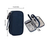 A navy blue portable digital accessory organizer pouch with a zipper and strap, shown next to an open clear storage case.