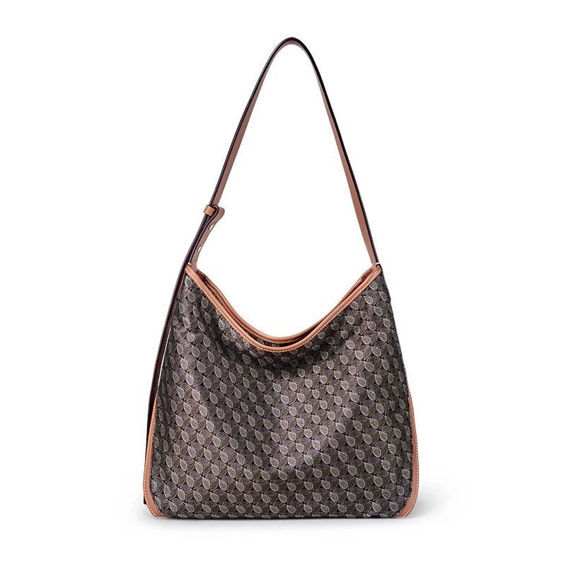 A brown geometric embroidery hobo shoulder bag with a long strap.