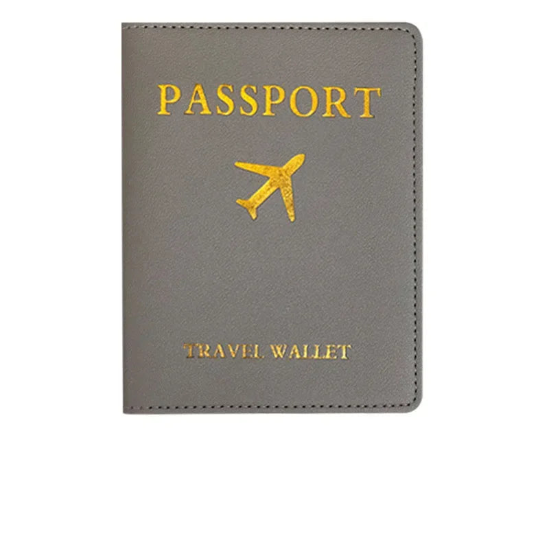 A gray PU leather passport holder with gold foil printing of an airplane and the word PASSPORT.