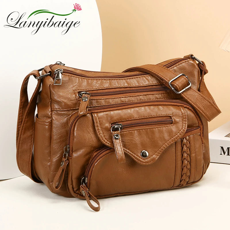 A brown leather tote bag with gold hardware and a woven detail is displayed on a white background.