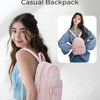 A young woman is holding a pink quilted backpack in a light blue shirt, demonstrating the casual backpack style.