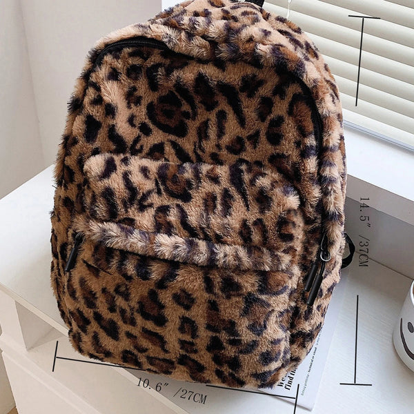 A brown and black leopard print plush backpack with multiple pockets shown on a white surface.