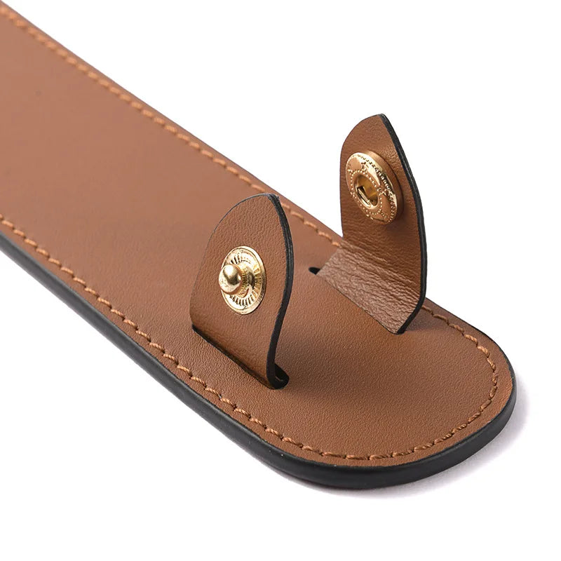 A brown leather carry loop with brass hardware is shown on a white background.
