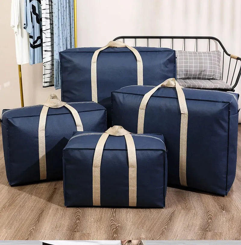 Navy blue foldable waterproof storage bags with tan straps displayed on a wooden floor.