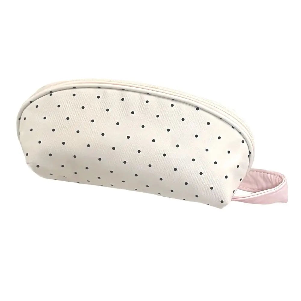 A light pink polka dot shell pencil case with a pink fabric strap.