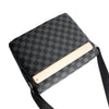 A black plaid crossbody shoulder bag with a light beige interior and a black strap.
