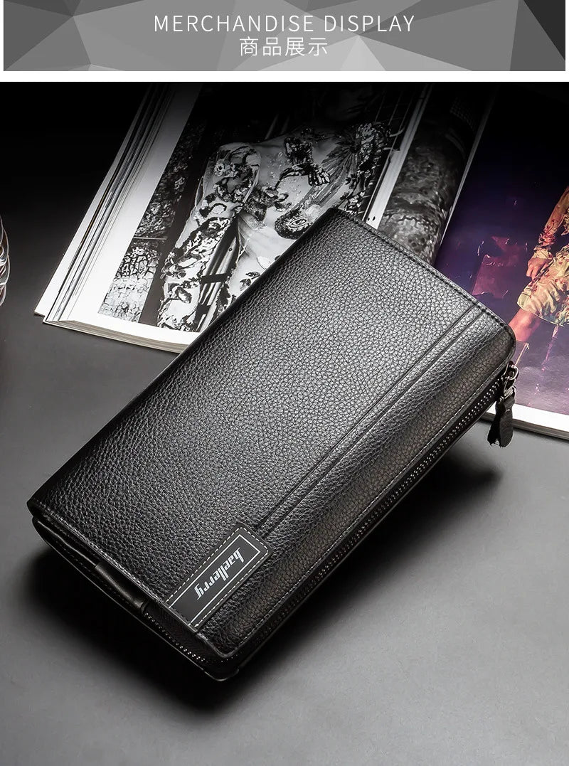 A black leather business handbag clip wallet displayed on a dark surface next to some magazines.