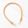 A light tan adjustable synthetic leather bag strap is shown against a white background.