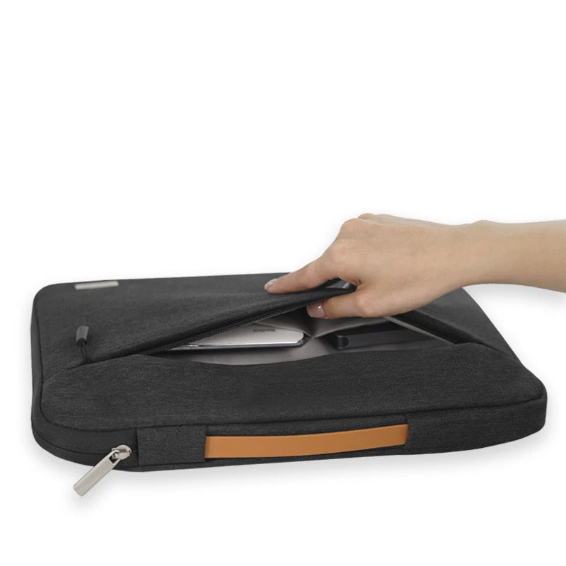 A hand is opening a black multi-pocket laptop sleeve with a handle.
