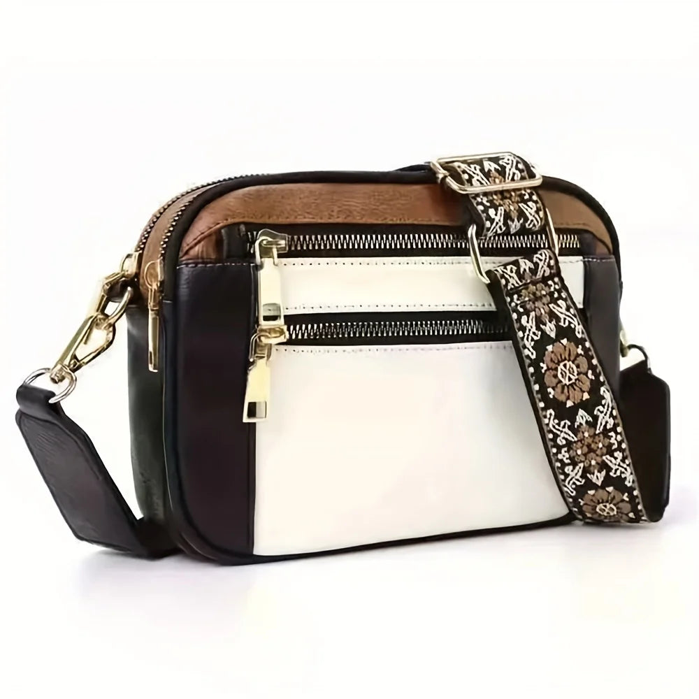 A brown and white PU leather crossbody bag with a black strap and gold hardware.