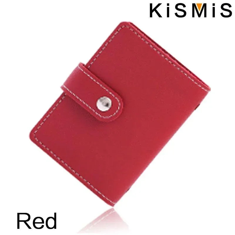 A red slim leather card holder with a stitched edge and a metal closure is shown from above.