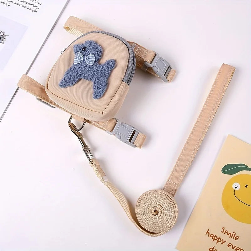 A beige adjustable dog vest with a gray backpack and leash featuring a round ball.