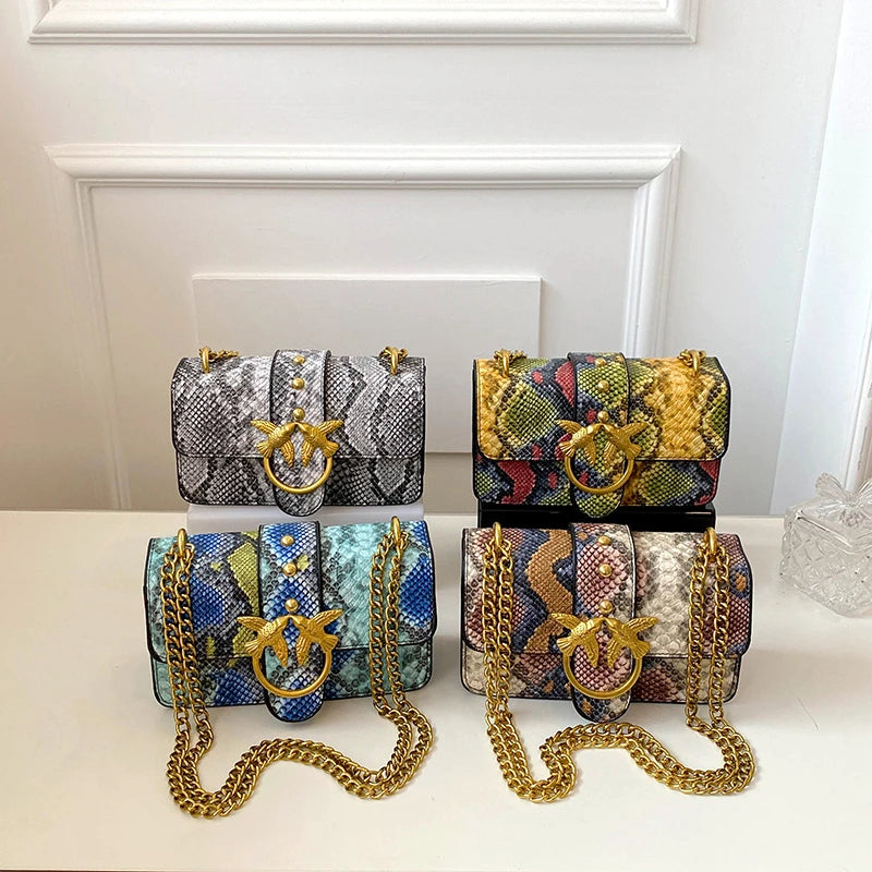 A set of elegant retro crossbody bags in black and gold patterned fabric with gold chain straps displayed on a white surface.