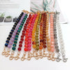 A display of handcrafted resin stone bead necklaces in various colors and shades arranged on a white background.