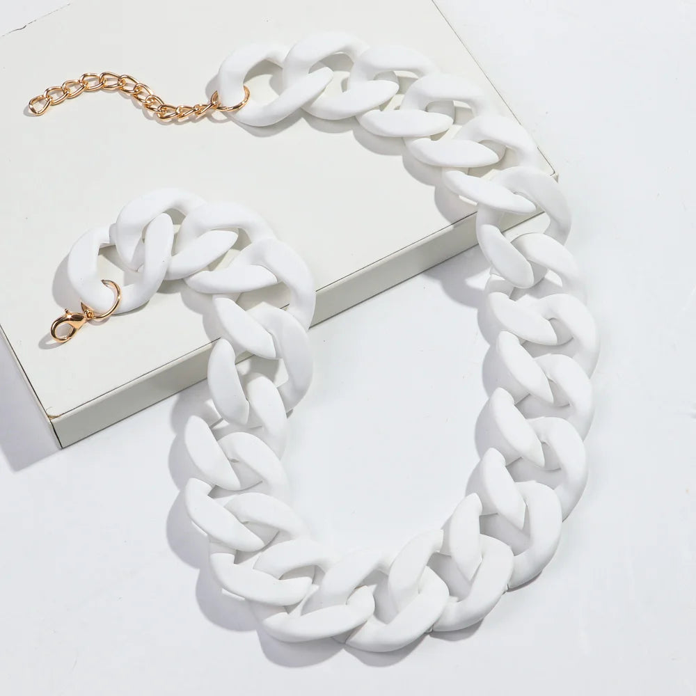 A white rope chain necklace with gold accents is displayed on a white box.