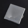 A rectangular silver metal cigarette storage box with radiating lines on the lid.