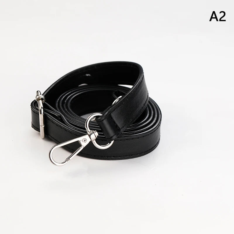 Black PU leather crossbody bag strap coiled and displayed against a white background.