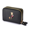 Black faux leather mini wallet with a gold letter J and floral print, featuring a double zipper.
