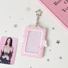 A pink angel wings photocard holder with a clear display case and a star charm on a white background.