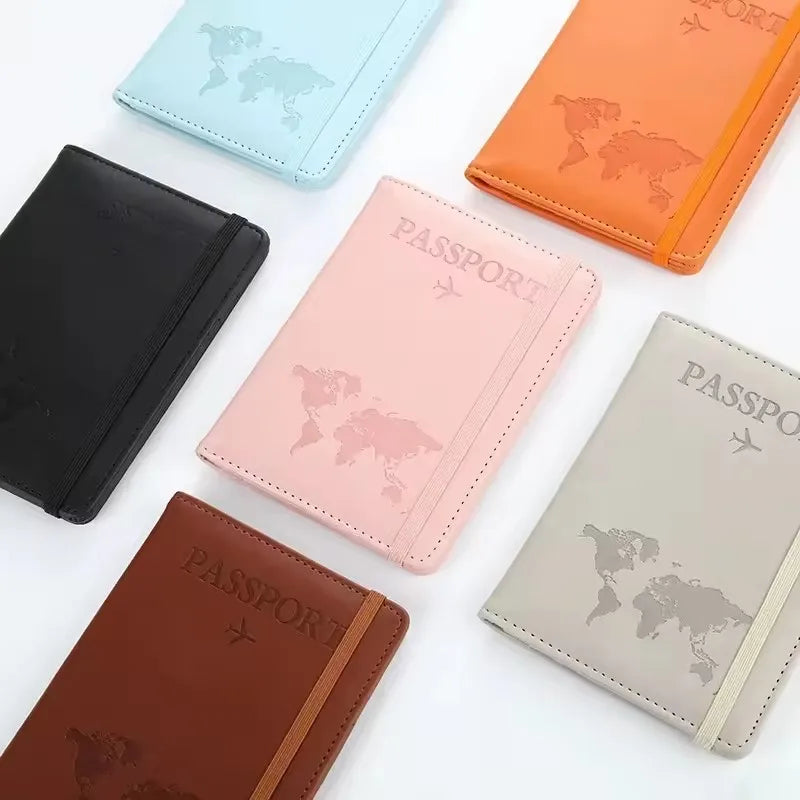 A collection of five slim passport holders in various colors including blue, orange, pink, brown, and beige.