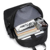 A black laptop backpack is open, showing a padded sleeve containing a camera and several notebooks.