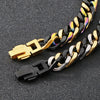 A close-up of a chunky Cuban link bracelet featuring gold and black metal links.