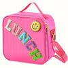 Pink insulated lunch bag with a smiley face patch and adjustable strap