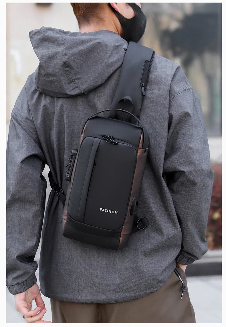 A man wearing a gray jacket is carrying a black anti-theft zippered crossbody bag on his back.