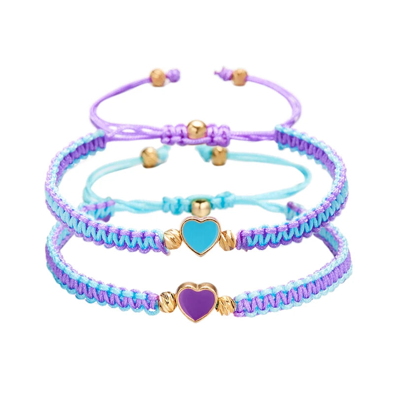 Three layered friendship bracelets featuring purple, blue, and lavender beads with gold accents.