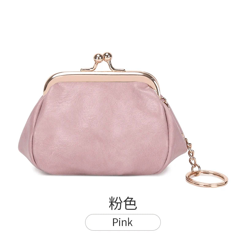 A pink leather coin purse with a gold-tone clasp and chain attached to the top.