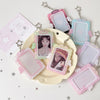 A set of pink and blue angel wings photocard holders with clear display cases and silver chains on a white background.