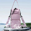 A pink adjustable strap thermal water bottle bag is shown splashing water on a rock surface.