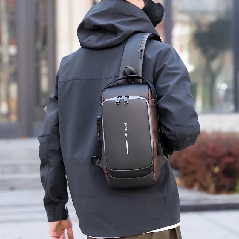 A person wearing a black jacket is carrying a dark gray anti-theft crossbody chest bag on their back.