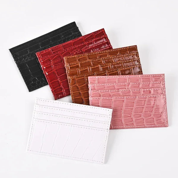 A collection of five slim PU leather card holder wallets in black, red, brown, pink, and white.
