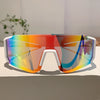 A pair of lightweight oversized sunglasses with a prismatic, multicolored lens resting on a light-colored surface.
