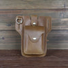 A brown genuine leather men's waist bag with a silver buckle and stitching, resting on a dark wooden surface.